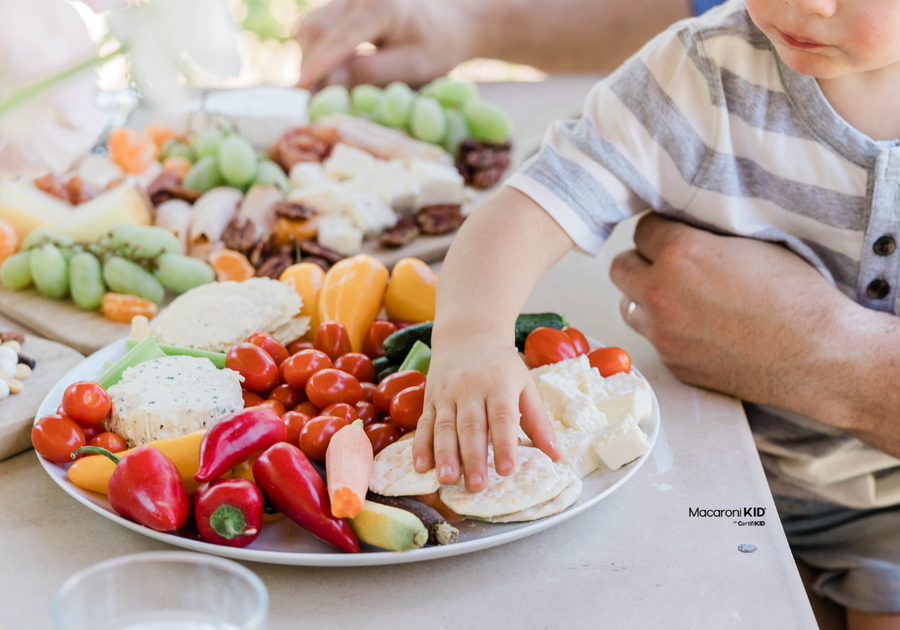 boy eating a charcuterie board -- one of 25 weeknight meals for kids moms love